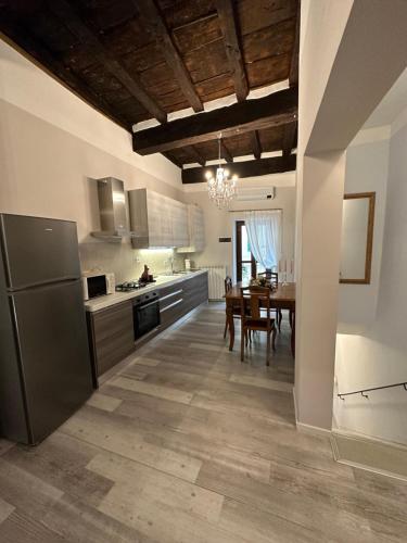 a kitchen with a table and a dining room at ANTICA DIMORA DEL BORGO Luxury TUSCANY in Bibbiena
