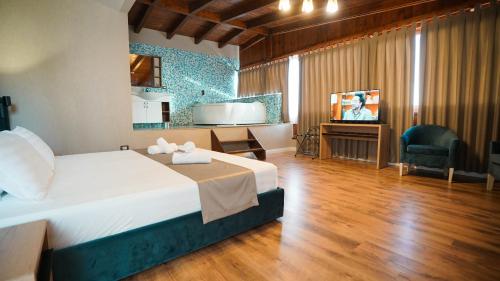 a hotel room with a bed and a television at Hotel Majestic in Durrës