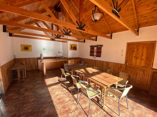 a dining room with wooden tables and chairs at Hermoso depto Pucon x Camino al Volcan in Pucón