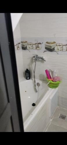 a bathroom with a sink and a faucet at Isila blanca in Sidi Bouzid