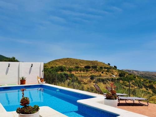 a swimming pool with a view of a hill at En-suite bedroom with private entrance at Casa Sofija in Sedella