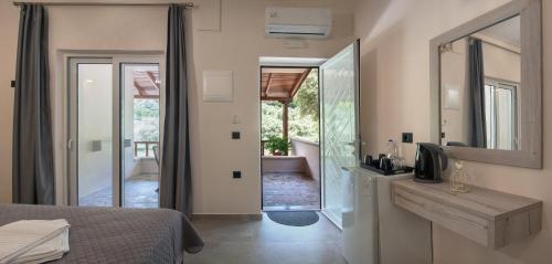 ein Schlafzimmer mit einem Bett und einem Spiegel sowie ein Badezimmer in der Unterkunft Antartisa B&B in Límni