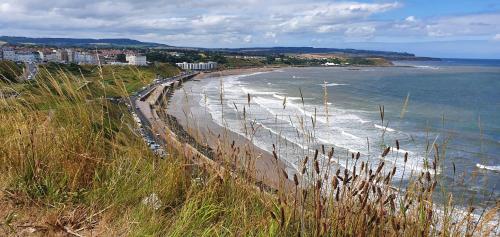 a view of a beach with the ocean and buildings at St Michael's Guest House in Scarborough