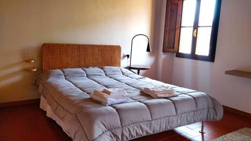 a bedroom with a bed with towels on it at Residence La Poggerina in Figline Valdarno