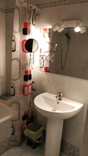 a bathroom with a white sink and a mirror at Residence La Poggerina in Figline Valdarno