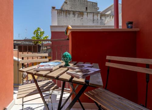 a table on a balcony with a view of a building at B&B Eraclio in Barletta