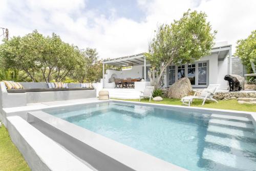 a swimming pool in the backyard of a house at Villa Valente in Mykonos with two pools! in Platis Gialos