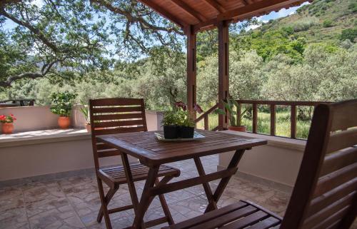 a wooden table and two chairs on a porch at Antartisa B&B in Límni