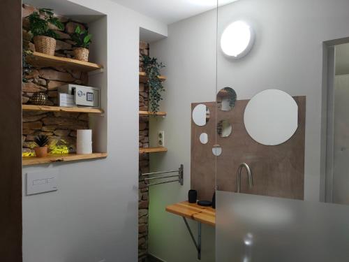 a bathroom with a sink and a mirror at La perle de Gordes in Gordes