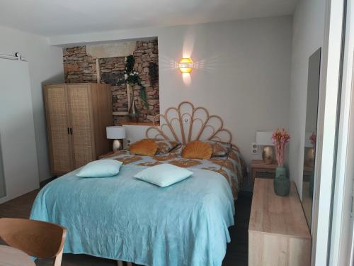 a bedroom with a bed with two pillows on it at La perle de Gordes in Gordes