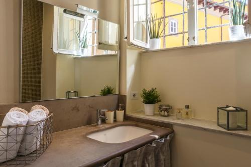a bathroom with a sink and a mirror at Stence Apartment in Lucca