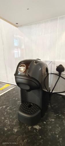 a hair dryer sitting on the floor in a room at Pearl Garden in Wembley in London