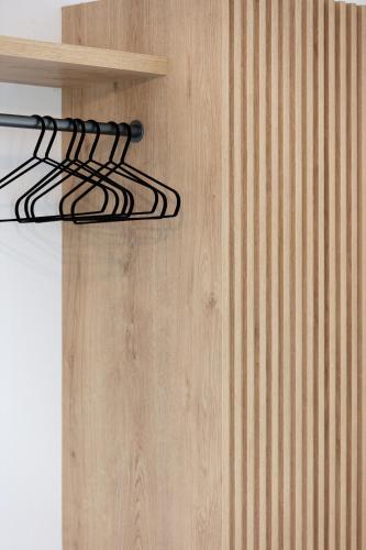 a bunch of wires hanging from a wooden wall at Eleftheria Studios in Balíon
