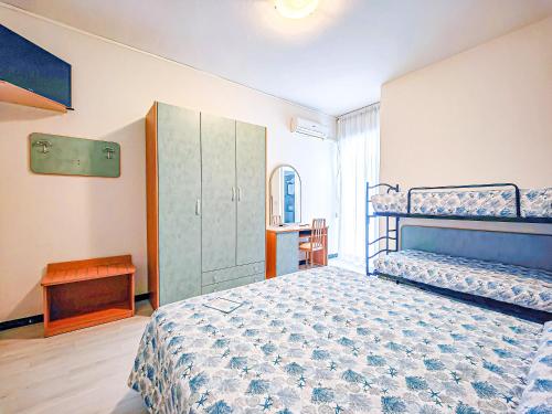 a bedroom with two bunk beds and a cabinet at Hotel Rio Beach & Breakfast in Cesenatico