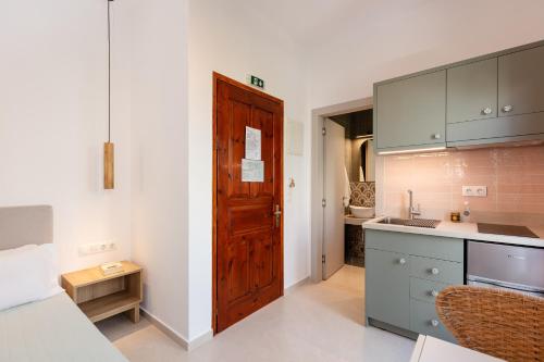 a kitchen with a wooden door and a counter at Eleftheria Studios in Balíon