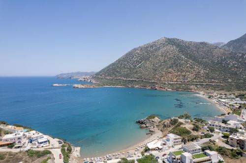 an aerial view of a beach with houses and mountains at Eleftheria Studios in Balíon