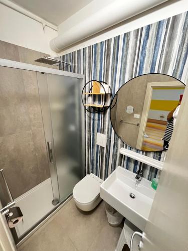 a bathroom with a shower and a toilet and a sink at Hotel Lido Vieste in Vieste