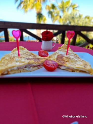 two sandwiches on a plate on a pink table at Villa Kristiano 21 in Sarandë