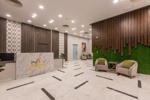 a lobby with chairs and a reception desk in a building at Gewan White Beach Resort-New Alamein in Marsa Matruh