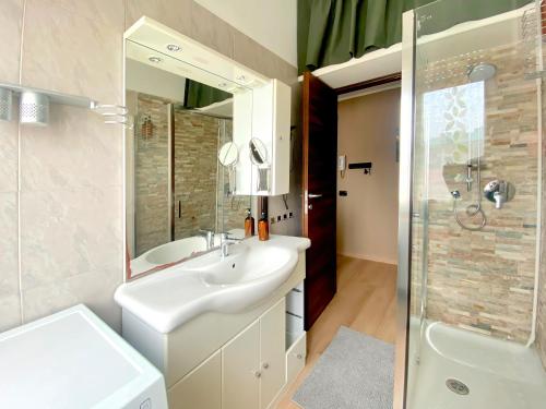 a white bathroom with a sink and a shower at Rho Fiera Milano Apartment in Pero