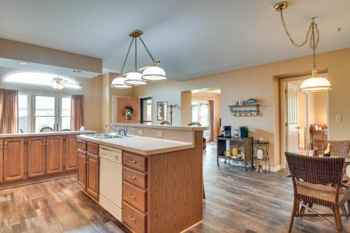a large kitchen with wooden cabinets and a large island at Tonawanda Vacation Rental about 13 Mi to Niagara Falls in Tonawanda