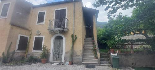 a house with stairs leading up to a door at Agriturismo Macchiapiede in Sala Consilina