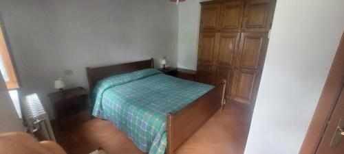 a small bedroom with a bed and a wooden cabinet at Agriturismo Macchiapiede in Sala Consilina