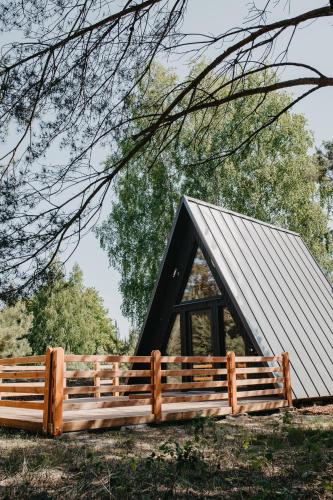 a barn with a wooden fence in front of it at MiLight in Aucugals