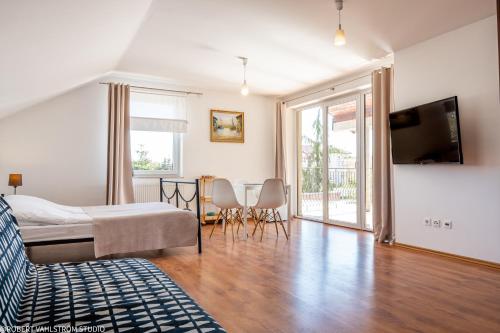 a bedroom with a bed and a table and chairs at Ośrodek Wypoczynkowy SWALLOW in Grzybowo