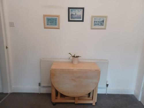 a table with a plant sitting on top of it at Twin room in Hoylake - 500 metres from Royal Liverpool Golf Course in Hoylake