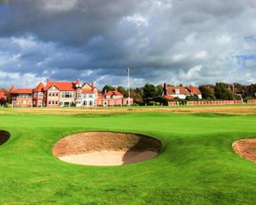 a green golf course with houses in the background at Twin room in Hoylake - 500 metres from Royal Liverpool Golf Course in Hoylake