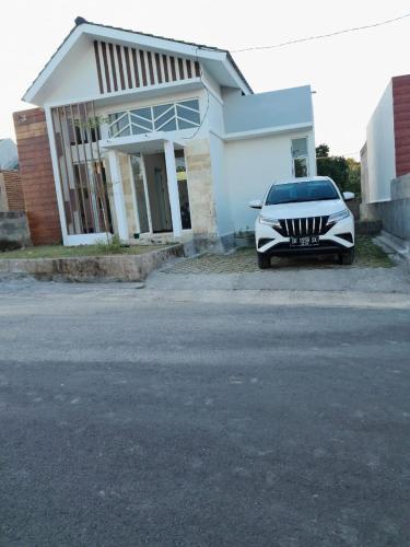 a white car parked in front of a house at Muja house villa in Praya