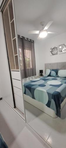 a reflection of a bedroom with a bed in a mirror at APARTAMENTO HECO in Peniscola