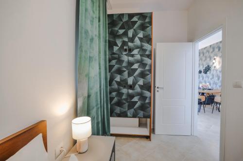 a room with a hallway with a table and a wall at Sunny Apts in Sarandë