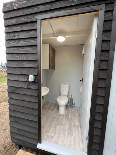 a bathroom with a toilet inside of it at Superior Luxury Large Emperor Tent in Stoke Goldington