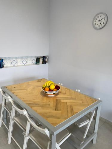 a bowl of fruit sitting on a wooden table at Tranquil sea view villa in Argostoli