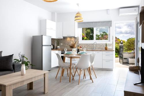 a kitchen with a table and chairs and a refrigerator at Casa il Megliore in Argostoli