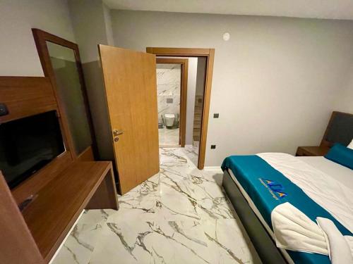 a hotel room with a bed and a marble floor at Uzungöl Bungalow in Uzungol