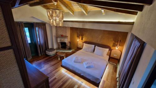 an overhead view of a bedroom with a bed and a fireplace at Bujtina Behram in Korçë