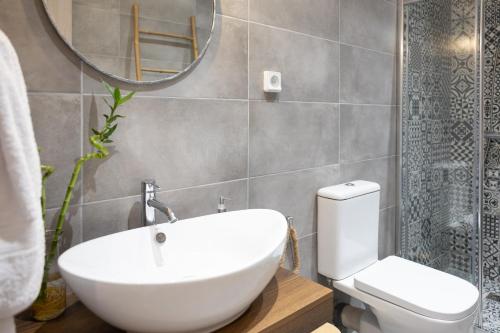 a bathroom with a sink and a toilet and a mirror at Casa il Megliore in Argostoli