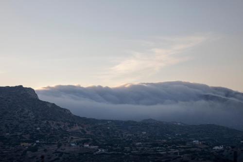 a group of clouds over a mountain range at Thea Menetes in Karpathos Town