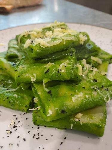 a plate of food with broccoli on a table at Hotel Lo Smeraldo in Roccavivara