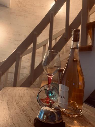 a bottle of wine and a glass on a table at La Casa Tamaris in Senta