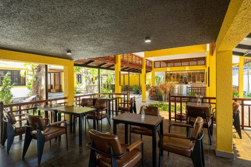 a restaurant with tables and chairs on a patio at Tuong Boutique Resort Mui ne in Mui Ne