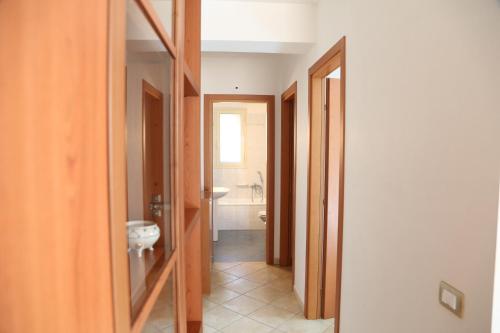 a hallway of a bathroom with a toilet and a sink at Casa Bonsai in Cava dʼAliga