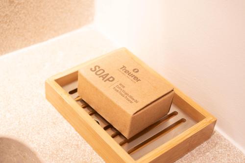 a box sitting in a wooden container on the floor at Fincahotel Treurer - Olive Grove & Grand House - Adults Only in Algaida