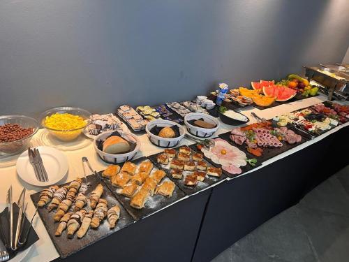 a table with many different types of food on it at Hotel Millenium deluxe in Selce
