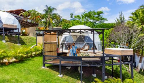 a house with a gazebo in a yard at Alma Glamping in Escazu