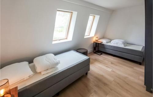 a room with two beds and two windows at Kavel 17 in Den Oever