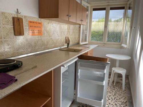 a small kitchen with a counter and a sink at Villa Maria Petru in Ierissos